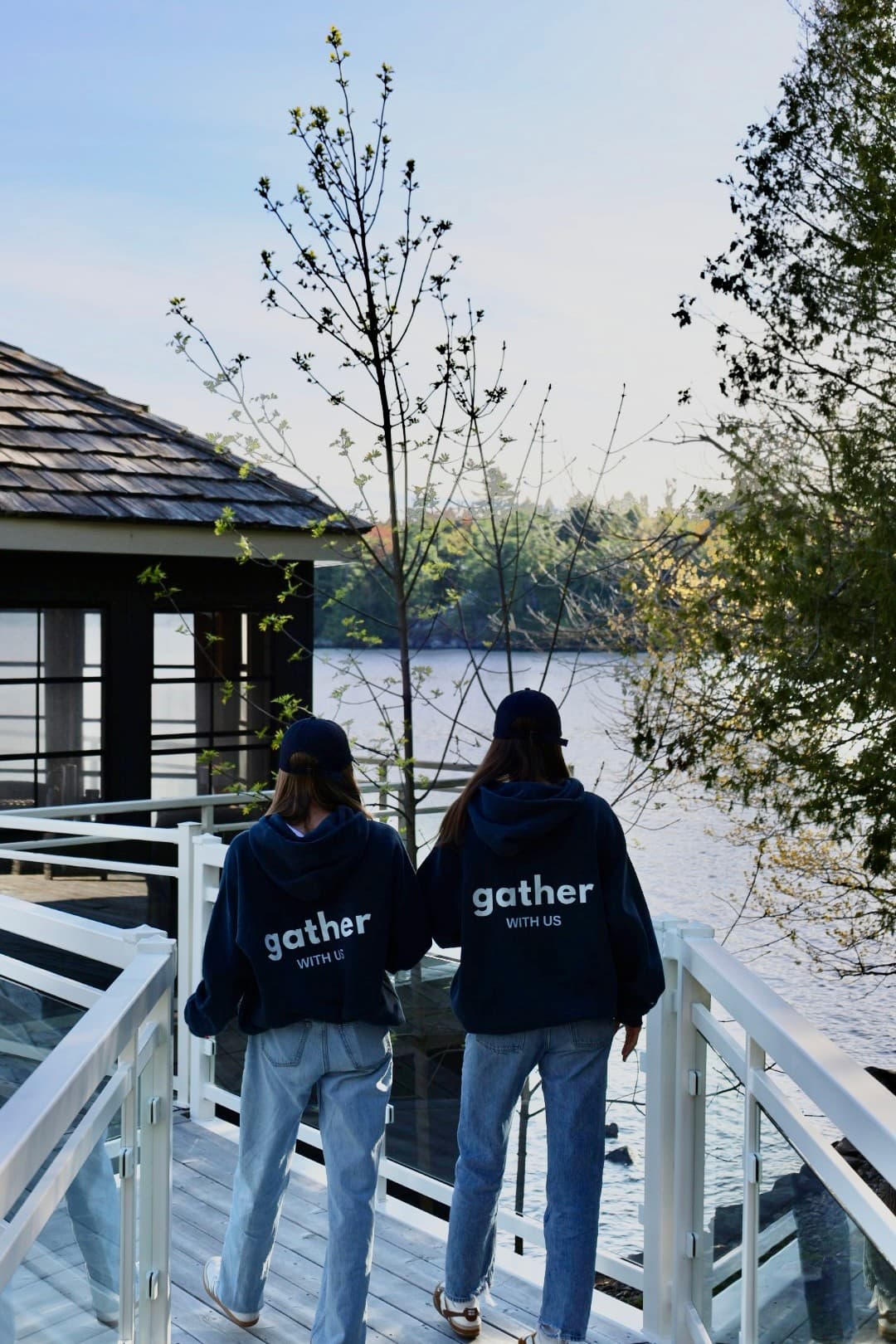 Gather founders walking onto a lakeside dock in matching gather hoodies